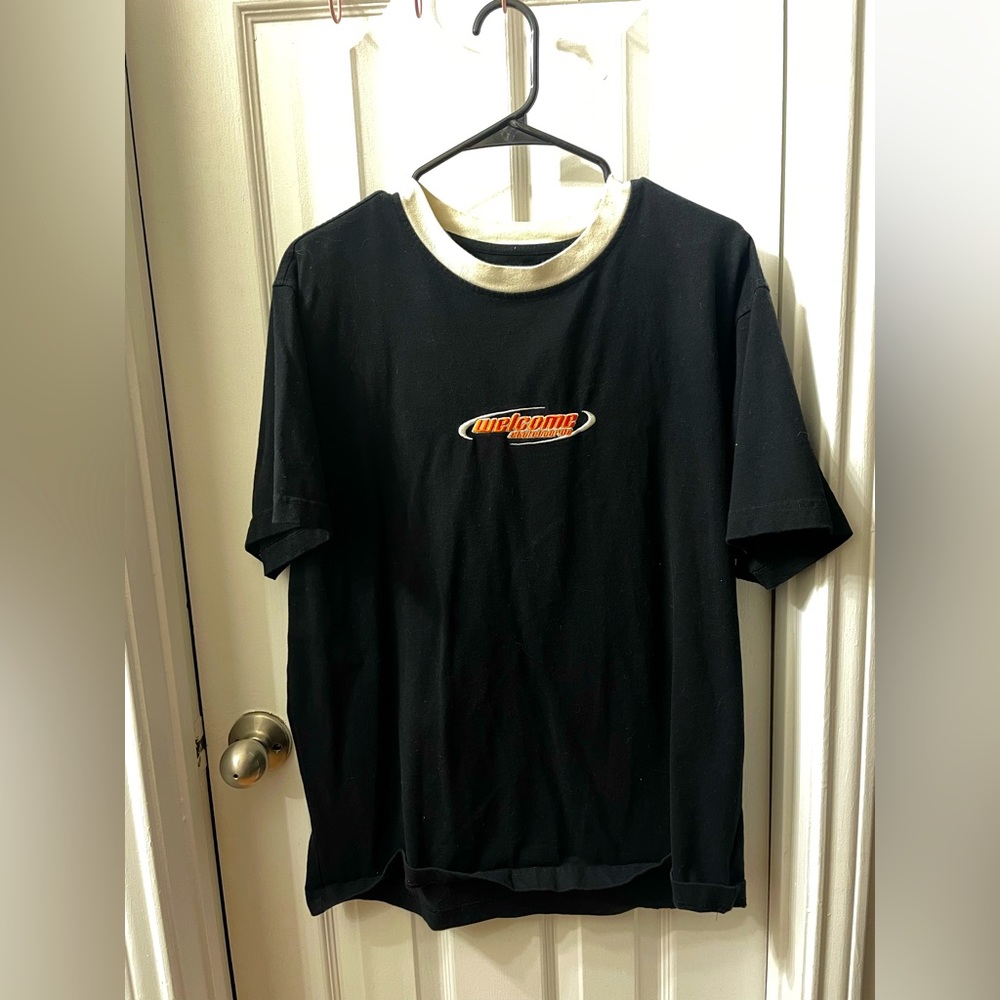 black short sleeve welcome t-shirt with white neckline and embroidered logo